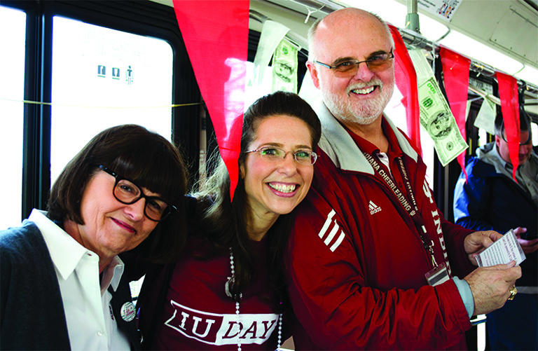 Picture of Carolyn Walters, Michelle Crowe and Chuck Crabb riding the A bus on IU Day.