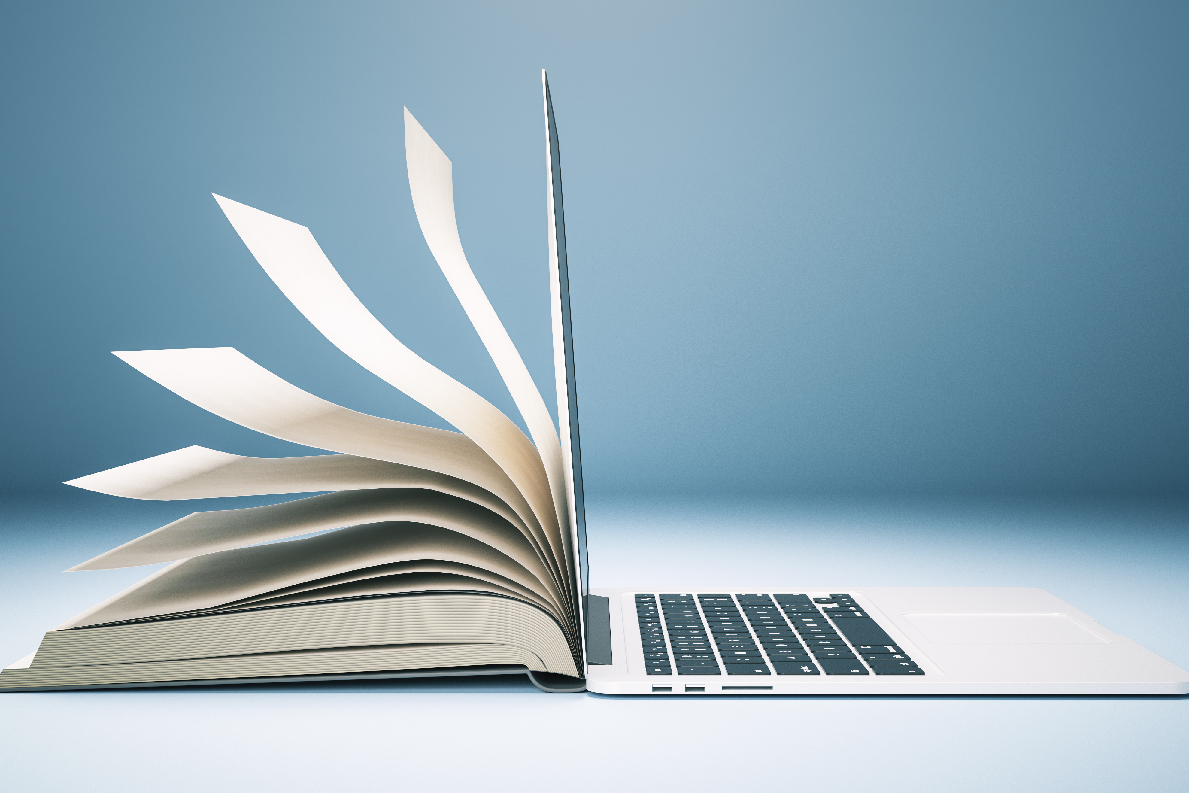 an image of an open book and an open laptop, back to back