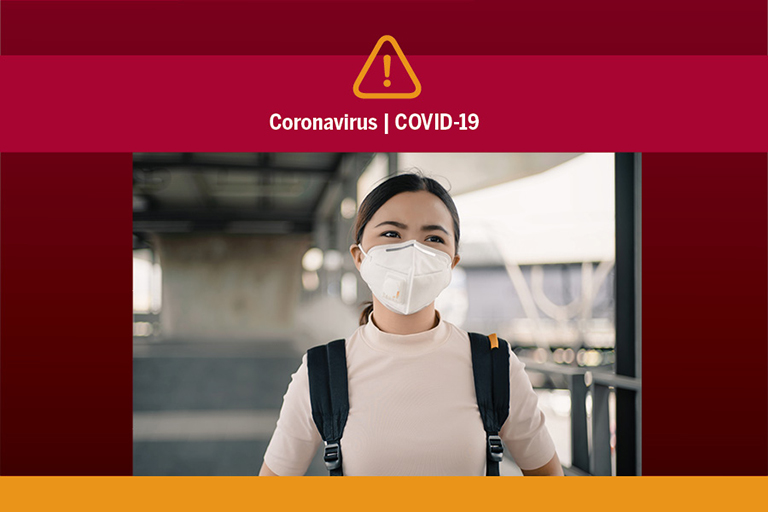 A person with hair pulled back in a ponytail wearing a backpack and a face mask. Above the photo is a "warning" icon (yellow triangle with exclamation mark) and the words "Coronavirus | COVID-19."