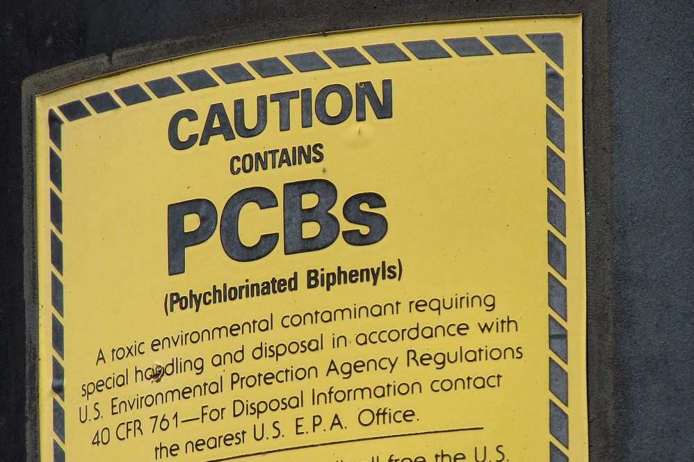 A yellow label warns "CAUTION contains PCBs."
