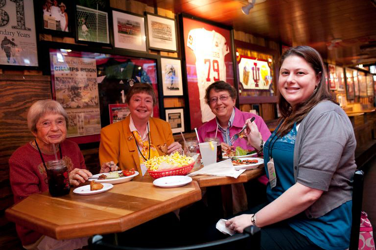 Four women sitting around a table at a restaurant.
