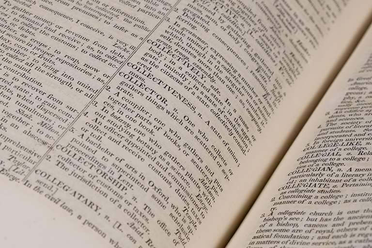 Photo of the 1928 Webster's Dictionary open to the entry for the word collector