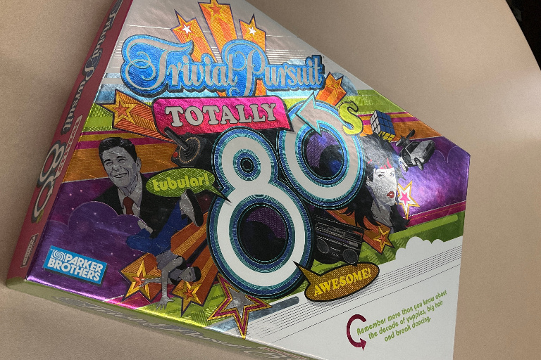 A brightly-colored box labeled Trivial Pursuit Totally 80's. Tubular! Awesome! Remember more than you know about the decade of yuppies, big hair and break dancing.