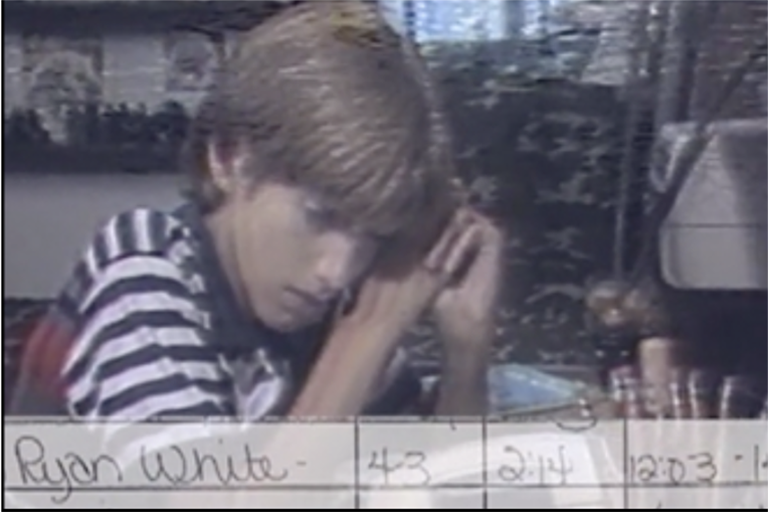 A still image from a news video raw archive. The handwritten label reads Ryan White.