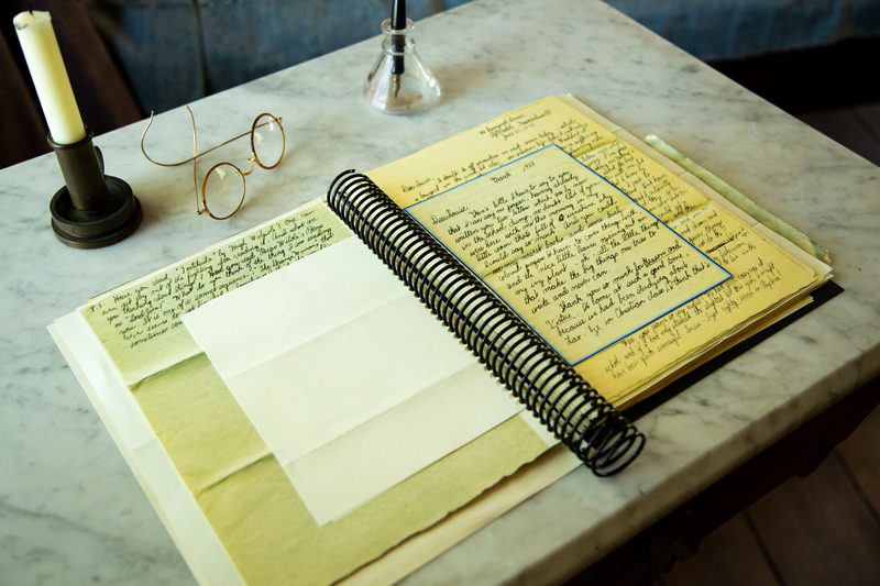 Reproduction 19th century letters bound and set upon a marble top table with spectacles