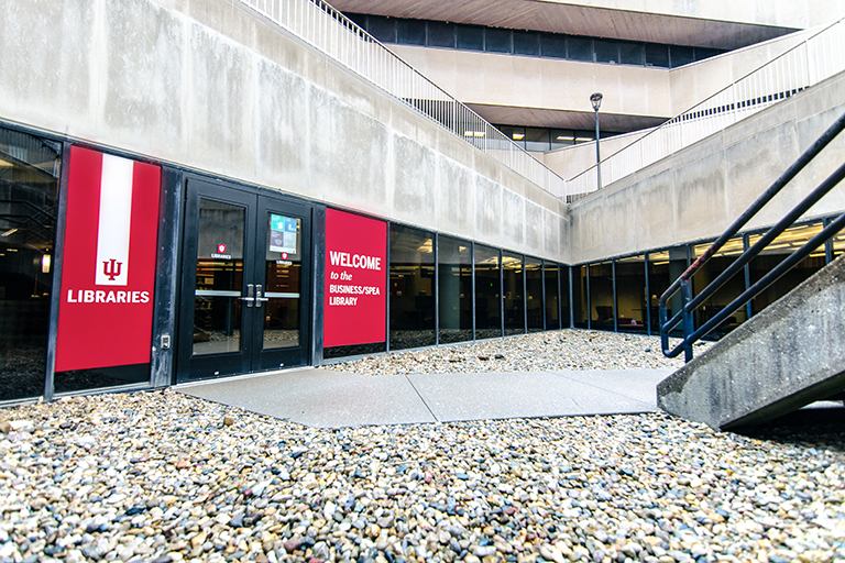 A wide angle image of large IU Red vinyl welcome panels on the exterior glass of the BUSSPEA Library.