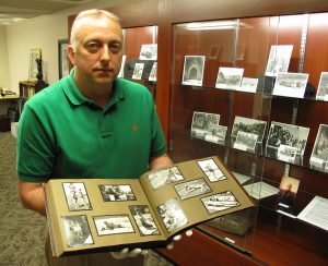 Brad Cook with a collection of archival photographs