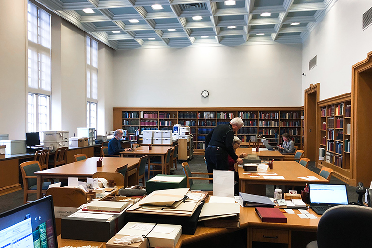 An interior view of the Lilly Library Read Room with a few patrons using materials on tables.