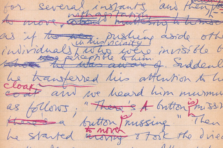 Detail of notebook page with handwritten text in blue and red, with many words crossed out and annotations