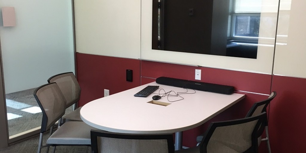 Music Library group study room showing conference table and large wall-mounted computer monitor.