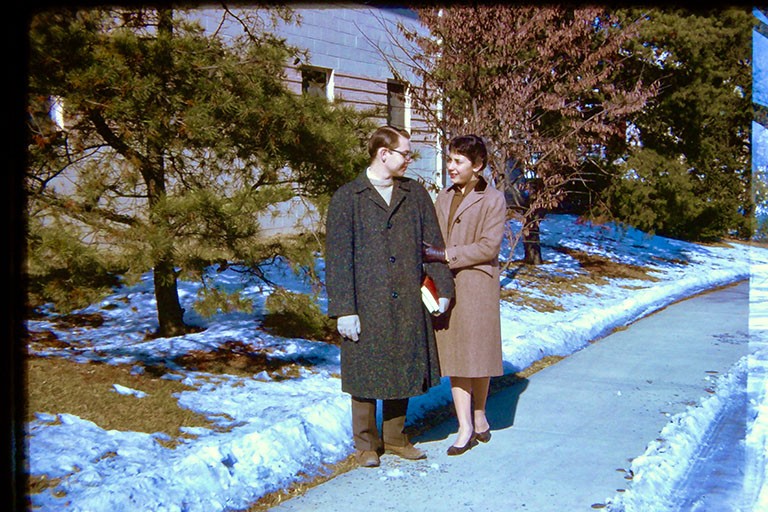 Color photo of Jim and Naomi Collins on a snowy sidewalk in Bloomington, IN circa 1963-64.