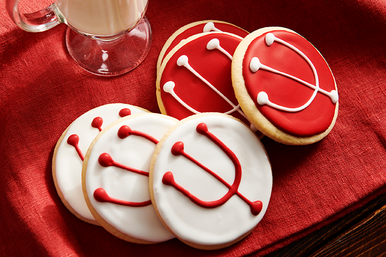 IU-branded sugar cookies, attractively positioned next to a glass of milk.