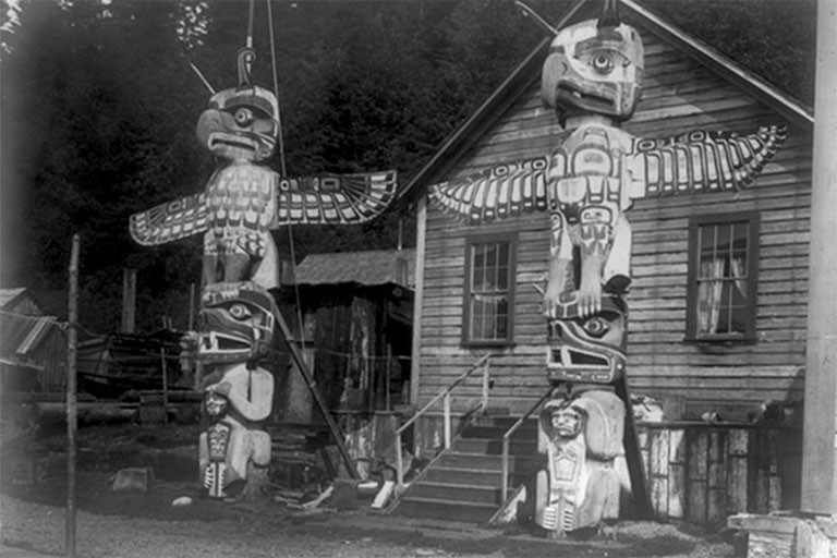 Two totem poles on Cormorant Island, 1914.