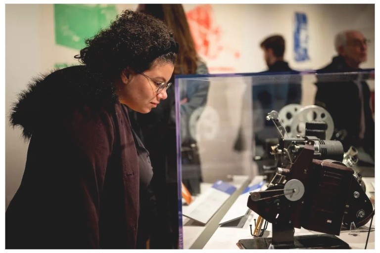 Ursula Romero, outreach librarian at the Indiana University Lilly Library, observes displays at the 16mm Exhibition Reception in the McCalla School