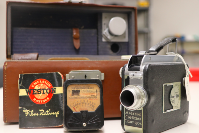 image shows antique camera and carrying case