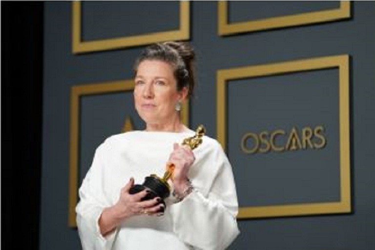 still image of a woman holding the "Oscar" award