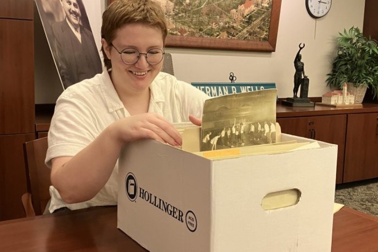 Jo Otremba, second year Archives graduate student, looking through a box with papers.