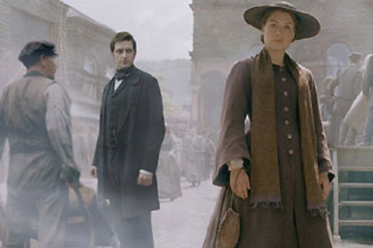 still image of a woman and two men from the movie "North and South"