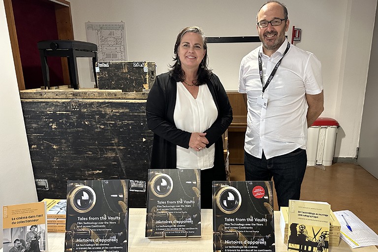 Co-editor Rachael Stoeltje (left) stands with Christophe Dupin, Senior Administrator with the International Federation of Film Archives (fiaf) with copies of the newly published book, Tales from the Vaults.