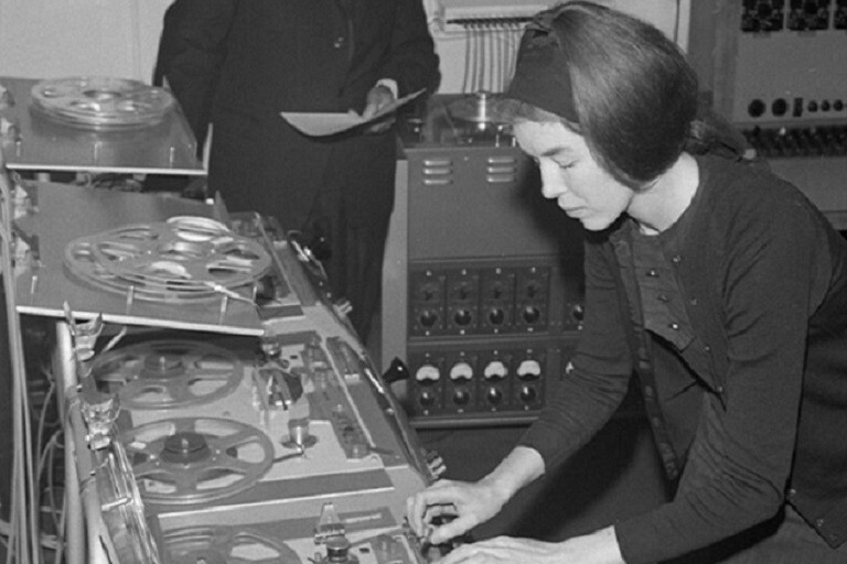 Delia Derbyshire composes using multiple reel-to-reel tape machines in June 1965. BBC 100