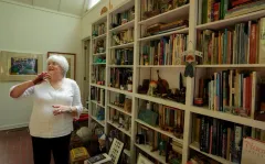 Children's book collector Flo Silver with her bookcases of books at home.