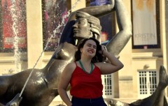 In a vivid red top and lipstick, Bruna stands in front of Showalter Fountain, her love of IU clearly on her face.