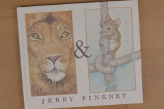 Book cover showing illustration of a lion's face, an ampersand, and a mouse clinging to a rope along with the author's name, Jerry Pinkney.